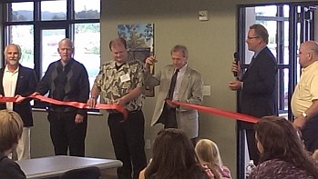 Randy Girard (3rd from right) cuts the Ribbon at the ALL NEW Marquette Township Offices on Commerce Drive!