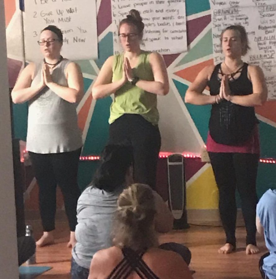 Nicki Owens, Khora Swanson, and Kelsey Reyes teaching a yoga class at Honor Yoga in Negaunee