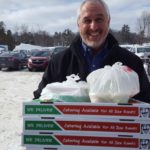 Bill Tibor delivering free Jet's Pizza to Frei Chevrolet during the broadcast