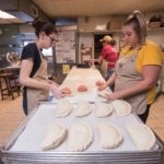The girls working on crimping the edges of the pasties.