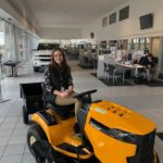 Lisa shows off the riding lawnmower that people can register to win at Frei Chevrolet