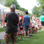 Crowds listening to music and watching softball during Community Day!
