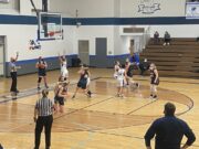 Negaunee's Morgan Carlson passes the ball in.