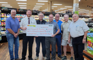 Marquette Township Board accepting the $1500 check from Super On