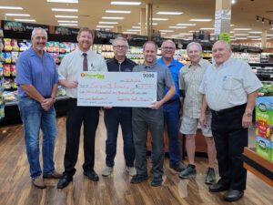 Marquette Township Board accepting the $1500 check from Super On
