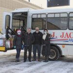 Sarah & Shari pose with Mark & Walt outside the D.J. Jacobetti Bus